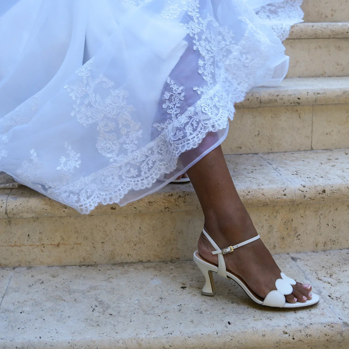 White leather sandal inspired by vintage Italian Riviera style with detachable straps for elevated occasion wear.