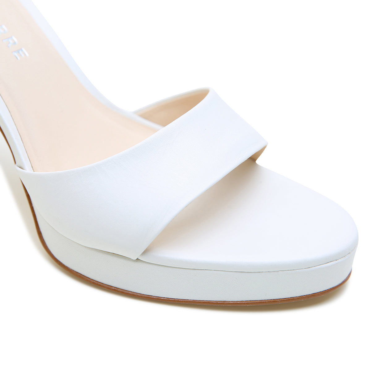 Alterre White Lo Platform combines leather upper and lining, composite leather sole with a 3.5-inch heel and 1/2-inch platform, a cushioned foam insole and interchangeable strap compatibility for versatile styling.