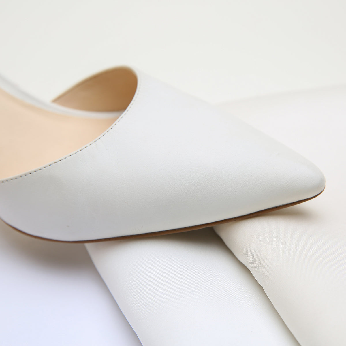 White Stiletto by Alterre, featuring genuine leather upper and sole, a 3-inch heel, a cushioned foam insole, and interchangeable strap compatibility.