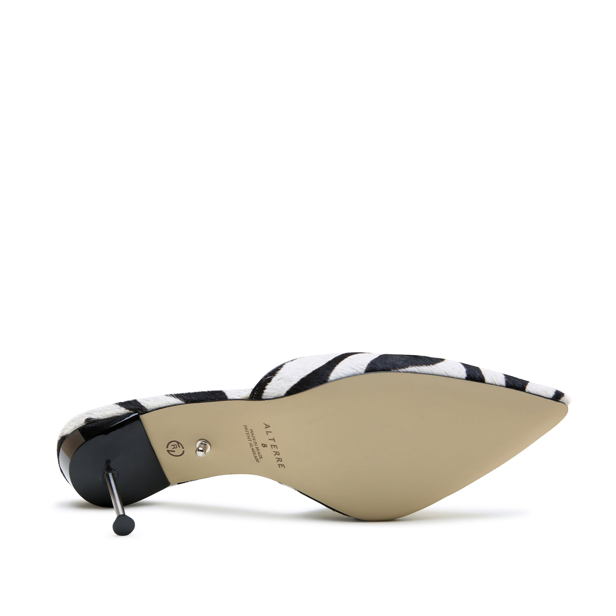 White Zebra Stiletto crafted with extended point for a wider toe box, interchangeable strap compatibility, and black-and-white zebra printed calf hair upper.